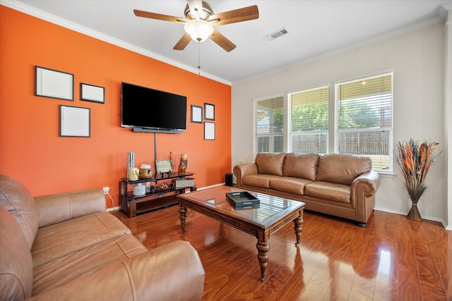 living room with wood finished floors, ceiling fan, ornamental molding, and baseboards