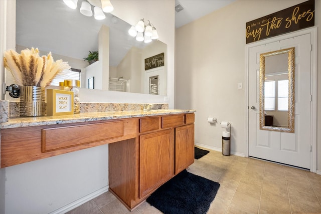 full bath featuring tile patterned floors, an enclosed shower, vanity, and baseboards