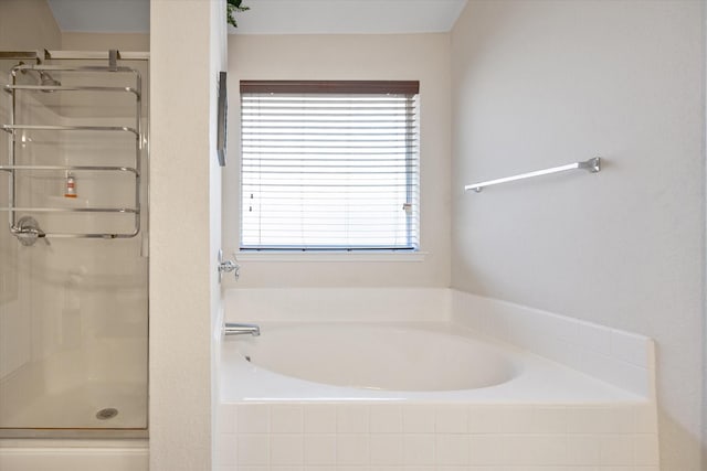 full bath with a stall shower and a bath