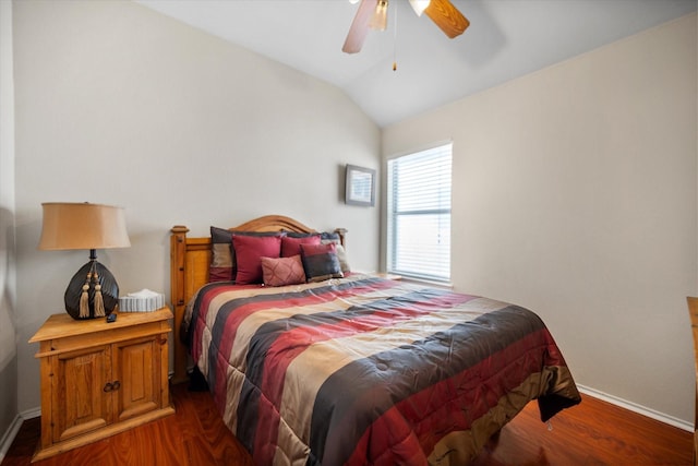 bedroom with lofted ceiling, wood finished floors, baseboards, and ceiling fan
