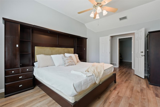 bedroom with light wood-style flooring, lofted ceiling, a ceiling fan, and baseboards