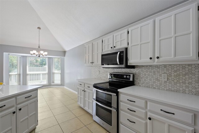 kitchen with stainless steel appliances, light tile patterned floors, decorative backsplash, vaulted ceiling, and a chandelier