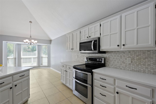 kitchen with stainless steel appliances, light tile patterned floors, decorative backsplash, vaulted ceiling, and a chandelier