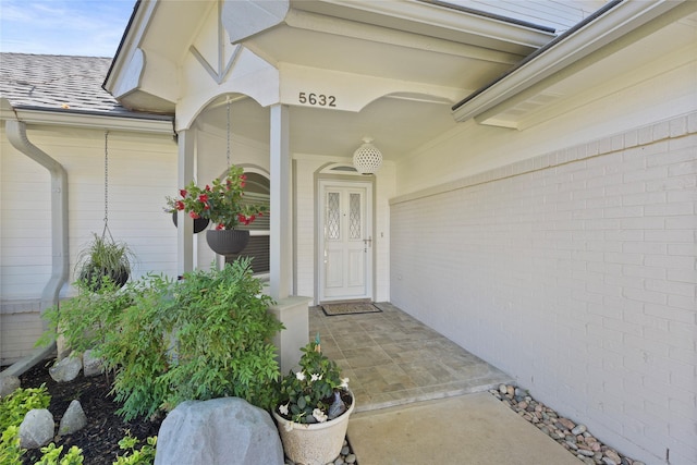 view of exterior entry with a porch