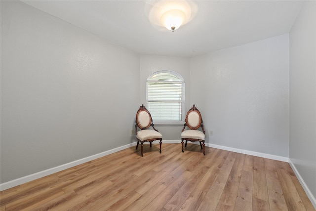 unfurnished room featuring light wood-type flooring and baseboards
