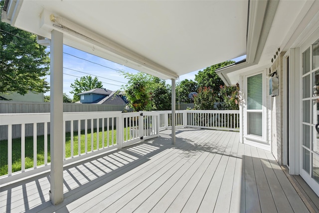 wooden terrace featuring fence