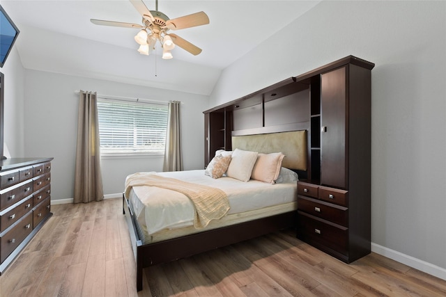 bedroom featuring vaulted ceiling, light wood-type flooring, baseboards, and ceiling fan