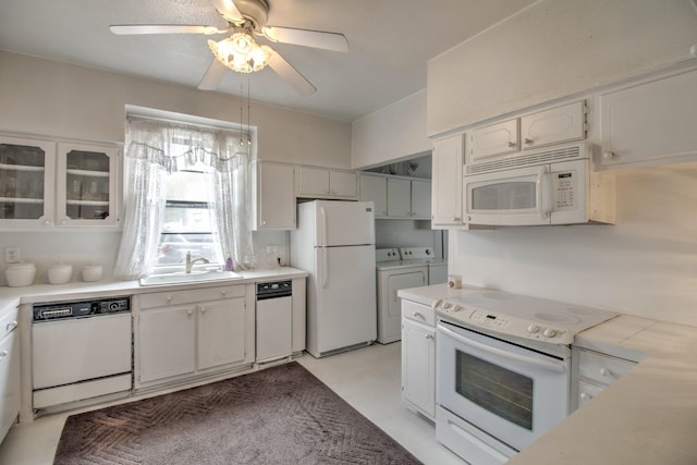 101 E Reed St, Randolph, TX 75475 - kitchen featuring white appliances, washer and dryer, a sink, a ceiling fan, and light countertops