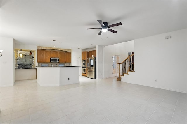 unfurnished living room with ceiling fan, stairs, and recessed lighting