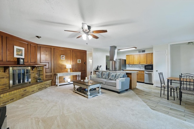 5220 Alpha Dr, The Colony, TX 75056 - living room featuring ceiling fan and a fireplace