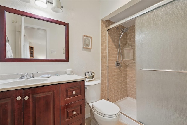 5220 Alpha Dr, The Colony, TX 75056 - bathroom with a shower stall, toilet, and vanity