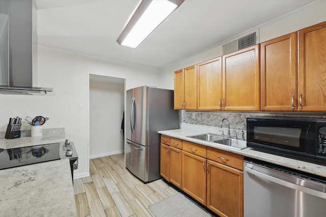 5220 Alpha Dr, The Colony, TX 75056 - kitchen featuring appliances with stainless steel finishes, a sink, wall chimney range hood, light countertops, and tasteful backsplash