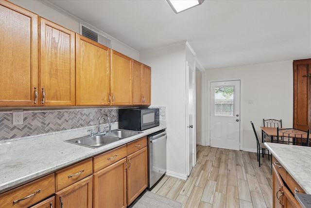 5220 Alpha Dr, The Colony, TX 75056 - kitchen with dishwasher, black microwave, a sink, light wood-style flooring, and backsplash