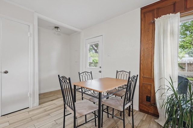 5220 Alpha Dr, The Colony, TX 75056 - dining room featuring light wood-style floors, baseboards, and crown molding