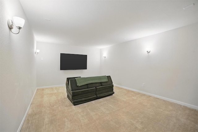 unfurnished room featuring light carpet and baseboards