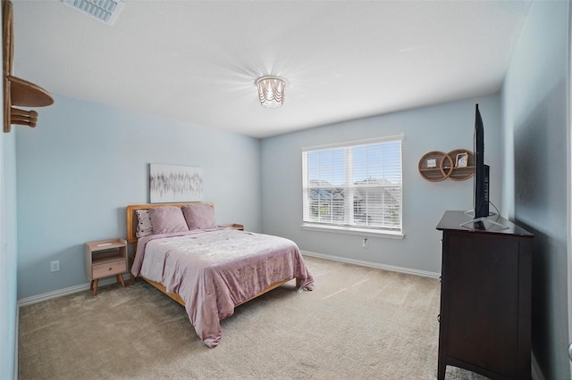bedroom featuring light carpet and baseboards