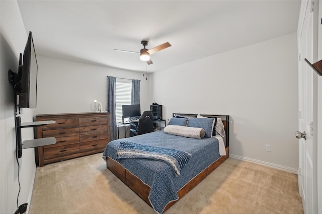 bedroom with carpet flooring, an office area, ceiling fan, and baseboards