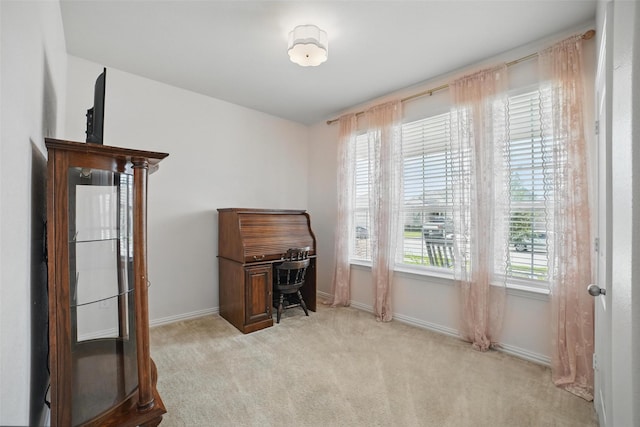 office area with light carpet and baseboards