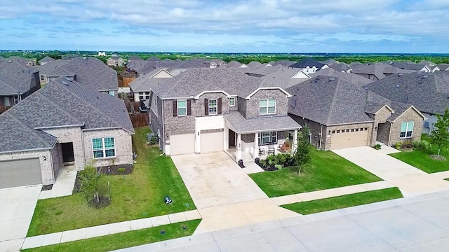 view of front of house with a residential view, concrete driveway, a front lawn, and a shingled roof