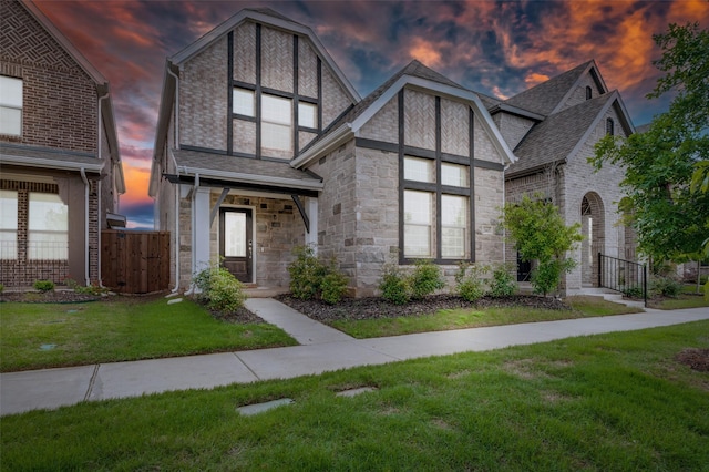 2665 Kings Canyon Mews, Corinth, TX 76210 - tudor-style house with stone siding, a shingled roof, and a gate