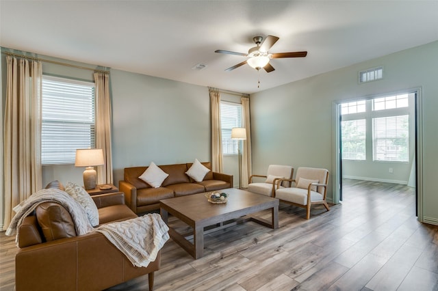 2665 Kings Canyon Mews, Corinth, TX 76210 - living area with ceiling fan, wood finished floors, plenty of natural light, and baseboards