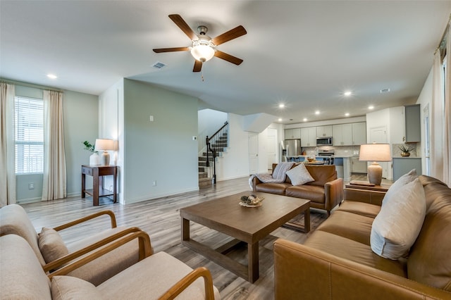 2665 Kings Canyon Mews, Corinth, TX 76210 - living room with stairway, a ceiling fan, baseboards, recessed lighting, and light wood finished floors