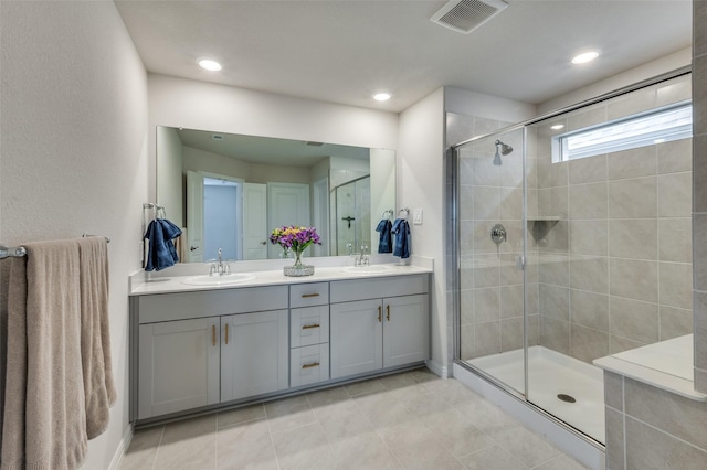 2665 Kings Canyon Mews, Corinth, TX 76210 - full bath featuring a shower stall, double vanity, tile patterned floors, and recessed lighting