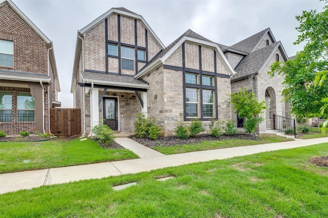 2665 Kings Canyon Mews, Corinth, TX 76210 - tudor-style house featuring stone siding, a shingled roof, and a gate