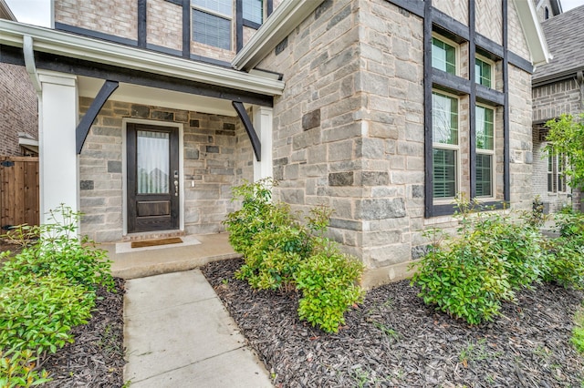 2665 Kings Canyon Mews, Corinth, TX 76210 - entrance to property featuring stone siding, fence, and a porch