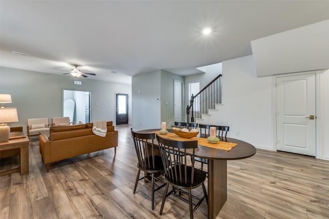 2665 Kings Canyon Mews, Corinth, TX 76210 - dining area with light wood-style floors, ceiling fan, stairway, and baseboards