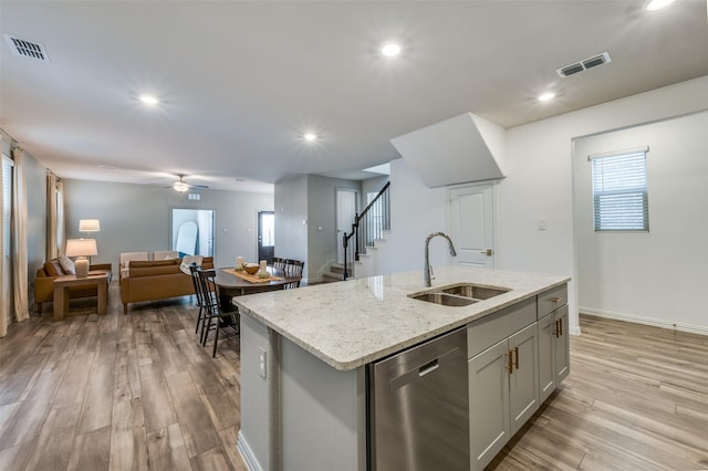2665 Kings Canyon Mews, Corinth, TX 76210 - kitchen featuring stainless steel dishwasher, a sink, open floor plan, light wood-style flooring, and recessed lighting