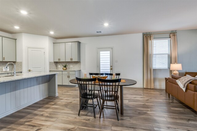 2665 Kings Canyon Mews, Corinth, TX 76210 - dining area with healthy amount of natural light, wood finished floors, recessed lighting, and baseboards