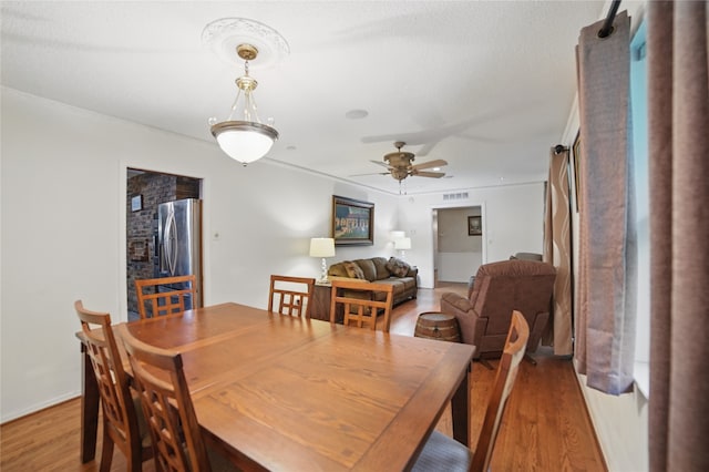 4548 Ivy Dr, Mesquite, TX 75150 - dining area with wood finished floors, a ceiling fan, and crown molding