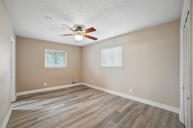 4548 Ivy Dr, Mesquite, TX 75150 - unfurnished bedroom featuring wood finished floors, a closet, a textured ceiling, and baseboards