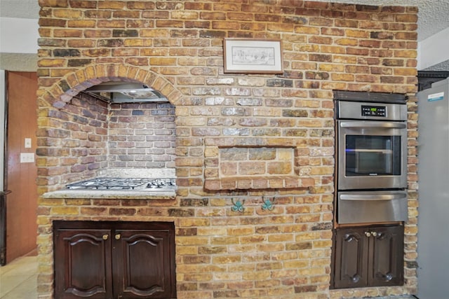 4548 Ivy Dr, Mesquite, TX 75150 - kitchen with a warming drawer, appliances with stainless steel finishes, a textured ceiling, and tile patterned flooring