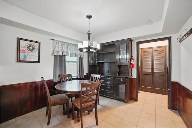 4548 Ivy Dr, Mesquite, TX 75150 - dining room featuring a chandelier, a wainscoted wall, and wood walls