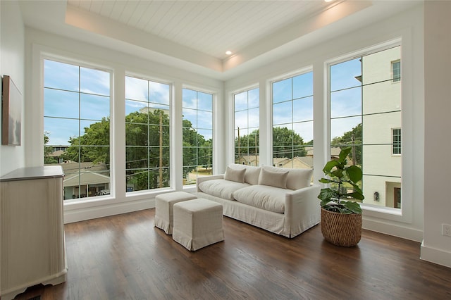 sunroom / solarium featuring a tray ceiling, plenty of natural light, wood finished floors, and recessed lighting