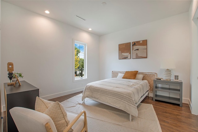 bedroom with dark wood-style flooring, recessed lighting, and baseboards
