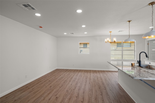 118 Mockingbird Ln, Hillsboro, TX 76645 - unfurnished living room featuring a sink, plenty of natural light, wood finished floors, baseboards, and recessed lighting