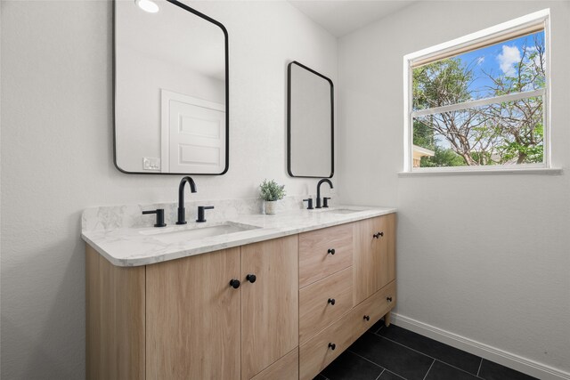 118 Mockingbird Ln, Hillsboro, TX 76645 - bathroom featuring double vanity, tile patterned flooring, and baseboards