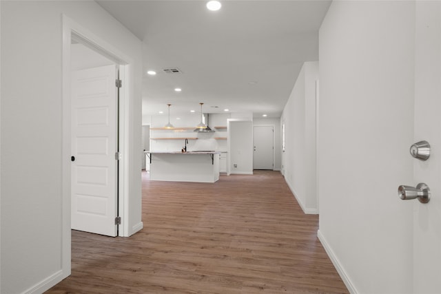 118 Mockingbird Ln, Hillsboro, TX 76645 - hallway featuring recessed lighting, light wood-type flooring, baseboards, and a sink