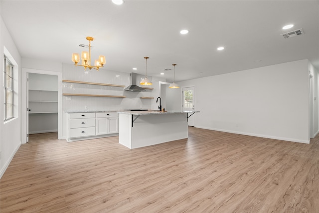 118 Mockingbird Ln, Hillsboro, TX 76645 - kitchen featuring open shelves, recessed lighting, wall chimney range hood, light wood finished floors, and white cabinetry