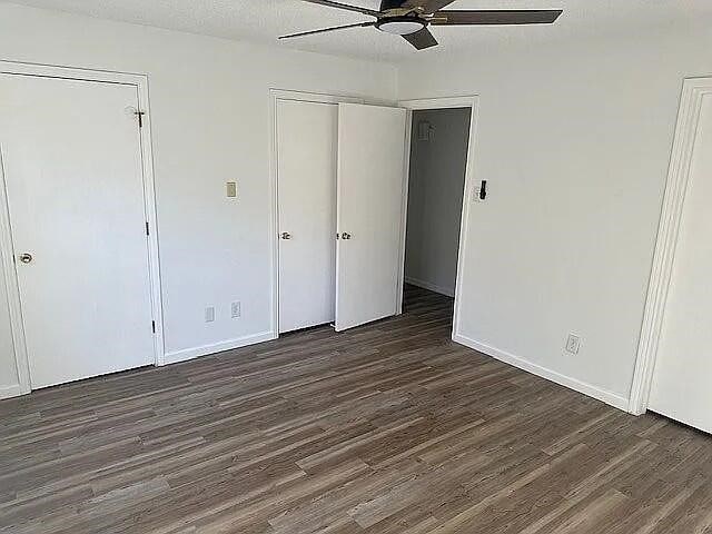 5817 Sandhurst Ln Unit B, Dallas, TX 75206 - unfurnished bedroom featuring wood finished floors, baseboards, and a ceiling fan