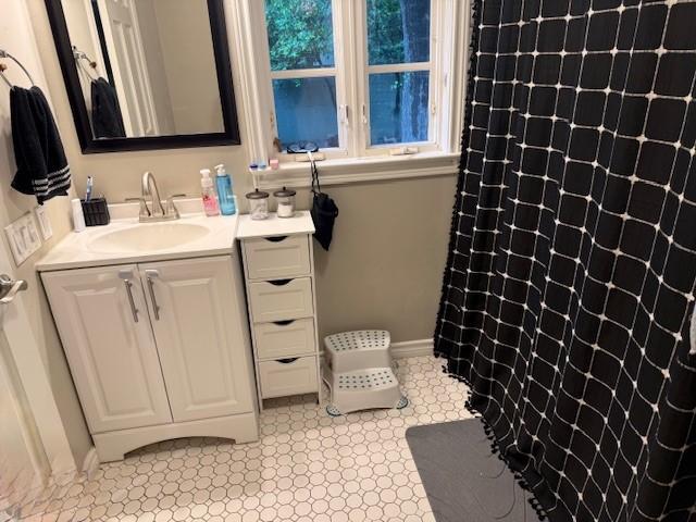 bathroom with vanity, a shower with shower curtain, and tile patterned floors