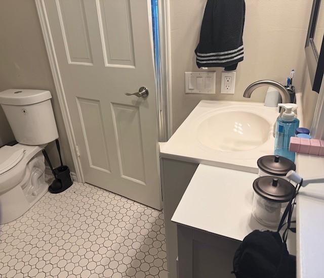 bathroom featuring toilet and vanity