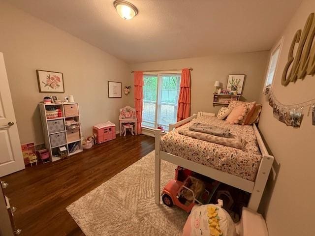 bedroom with dark wood-style floors