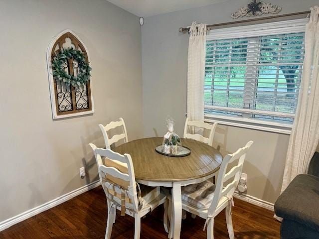 dining space featuring baseboards and wood finished floors