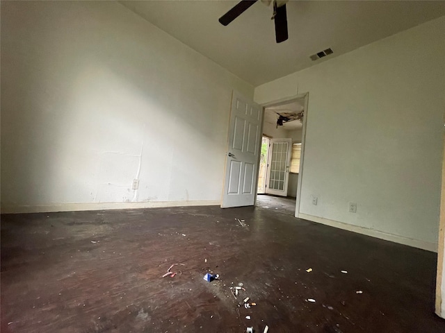 spare room with a ceiling fan and baseboards
