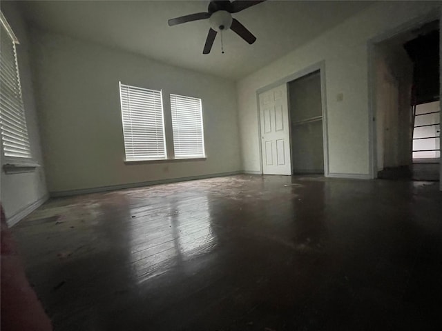unfurnished bedroom with baseboards, a closet, and a ceiling fan