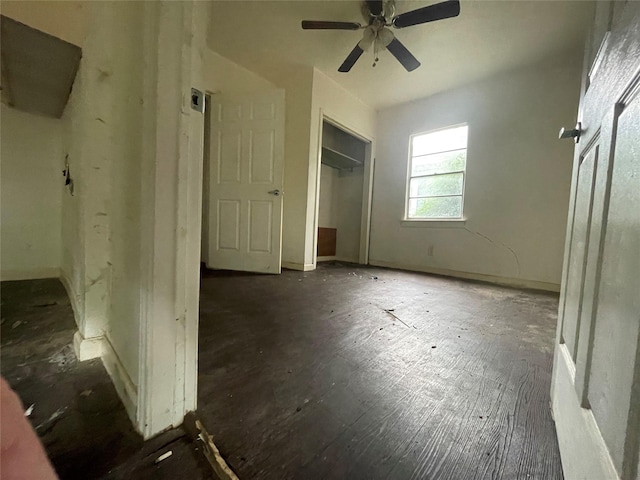 unfurnished bedroom with a ceiling fan and baseboards